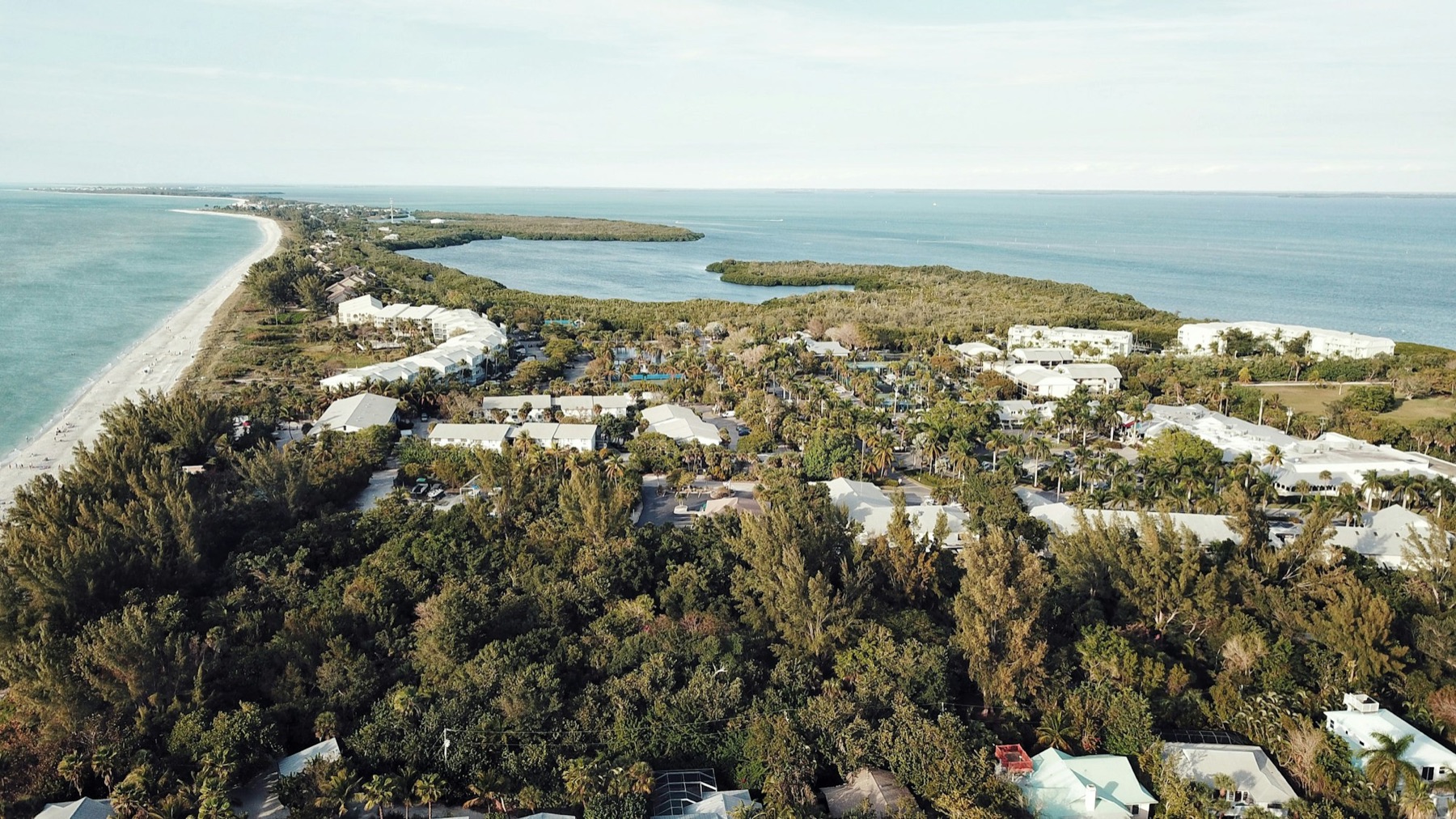 Aerial view of the Sarasota Gulf coast with white quartz-sand beaches, turquoise water, and waterfront homes